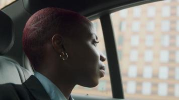 Young businesswoman sitting in back of cab video