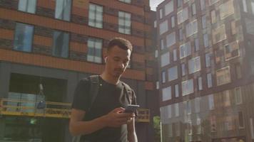 Slow motion of young man texting on smartphone video