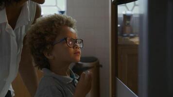 Mother and son waiting for homemade cookies to come out of oven video