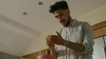 Young man lighting candles on birthday cake video