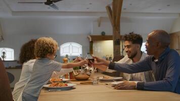 familia brindando con copas de vino en la cena video