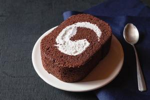 Chocolate cake on black table. photo