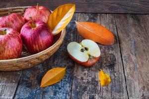 Red apples on an old wooden table photo