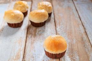 Fresh cupcakes on a wooden table photo
