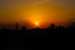 Silhouette of city in sunset photo