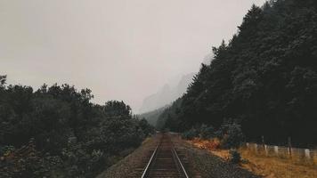 Rail road tracks with mountains in distance photo