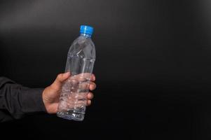Man holding a plastic bottle photo