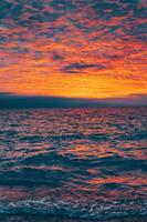 Bright sunset over rippling ocean photo