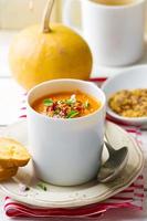 pumpkin soup in a white mug photo