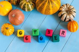 Word October On child's toy cubes and Autumn harvest photo