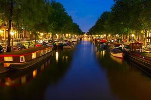 Night city view of Amsterdam canal with Houseboat
