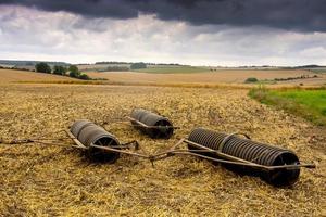 Farming Equipment under stormy sky photo