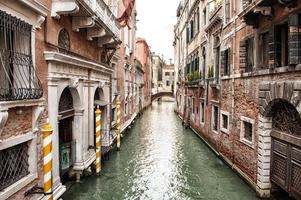Narrow Venetian Canal Lined with Buildings photo