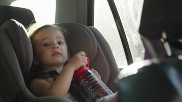 Slow motion of girl in car seat on journey video
