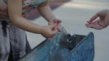 Slow motion of girl touching water in fountain video