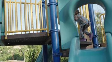 Slow motion of girl on climbing frame in play park video