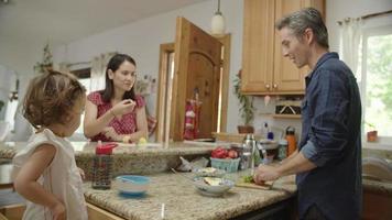 Slow motion of man preparing food with family video