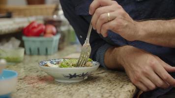Slow motion of man eating healthy lunch