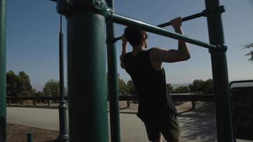 Slow motion of mid adult man doing pull ups video