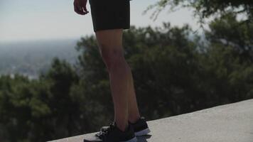 Tilt up of man in sports clothing standing outdoors