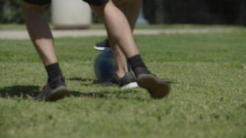 Two men playing soccer on grass