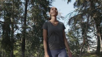 Slow motion of young woman walking through woods video