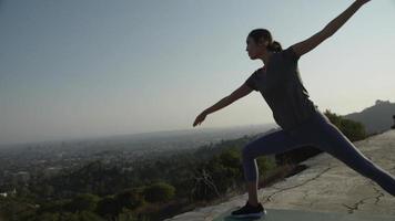 Slow motion of woman practising yoga