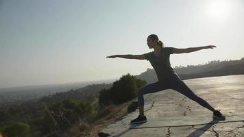 Slow motion of woman practising yoga