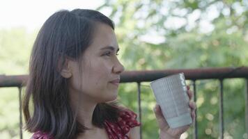 Slow motion of woman drinking cup of coffee and smiling video