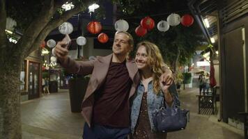 Slow motion of loving couple taking selfie in Chinatown video