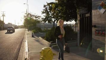 Slow motion of businesswoman walking down pavement video