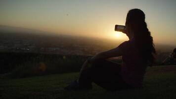 Slow motion of woman photographing city with phone video