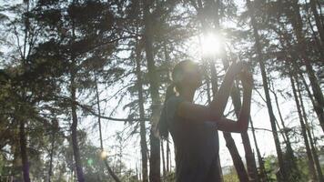 Slow motion of woman taking photo on phone in forest video