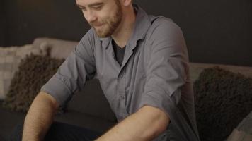 cámara lenta de hombre usando laptop en sofá video