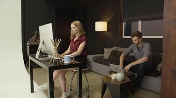 Slow motion of couple using computers at home