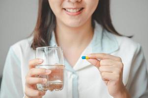 Woman holding pill photo