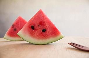 Slices of watermelon on wooden desk photo