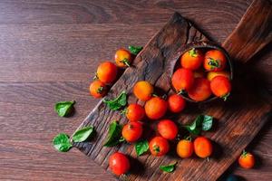 Fresh red tomatoes on wooden background photo