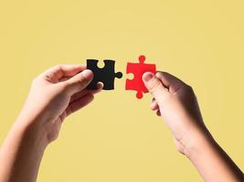 Hands holding jigsaw puzzle pieces photo