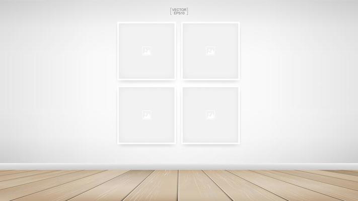 Four empty square photo frames on white wall