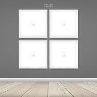 Four empty square photo frames on gray wall vector