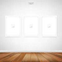 Three empty photo frames on white wall vector