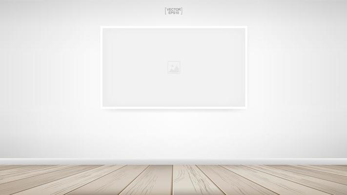 Empty photo frame on white wall in room space