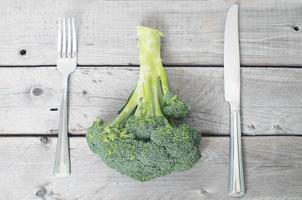 Fresh broccoli on aged wooden table photo