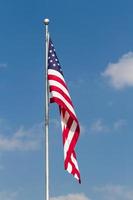 US Flag on Pole with Blue Sky photo