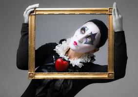 Woman in disguise harlequin in the picture frame photo