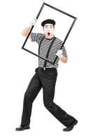 Mime artist holding a big picture frame photo