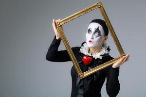 Woman in disguise harlequin in the picture frame photo