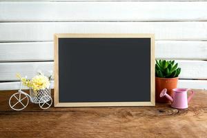 Shelf decoration with blackboard and flower on white background