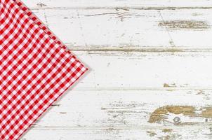 Red tablecloth over wooden table photo